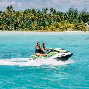 Two women jet skiing in Bora Bora