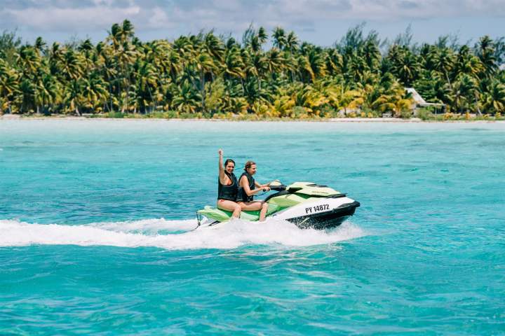 Two women jet skiing in Bora Bora