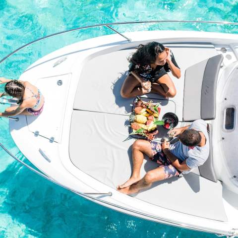 A family enjoying a fruit platter on Cap Camarat boat in Bora Bora