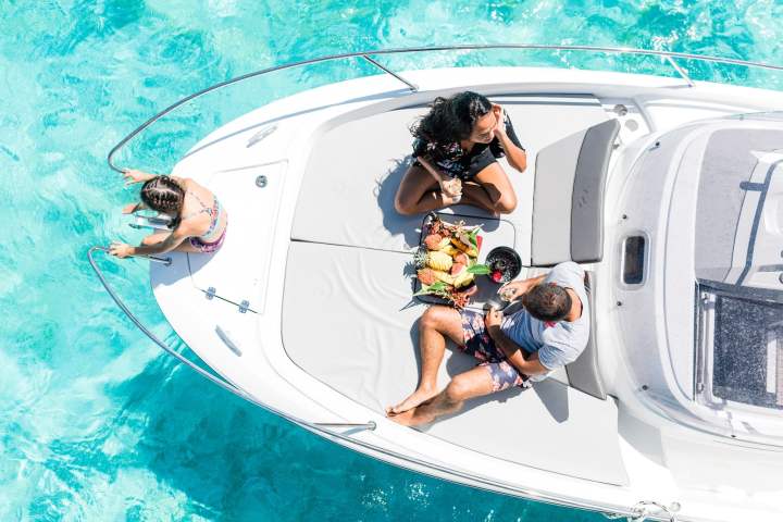 A family enjoying a fruit platter on Cap Camarat boat in Bora Bora