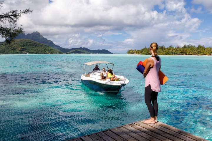 a man in a blue boat on a body of water