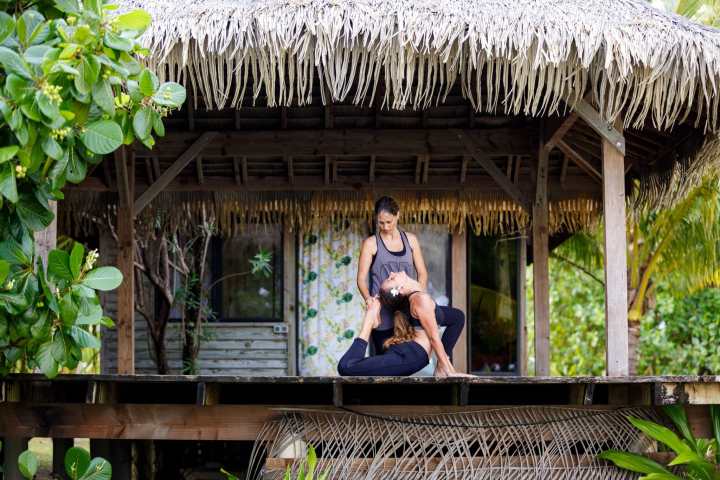 a person sitting on a bench in front of a building