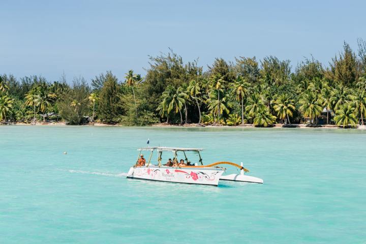 A Polynesian outrigger sailing in Bora Bora