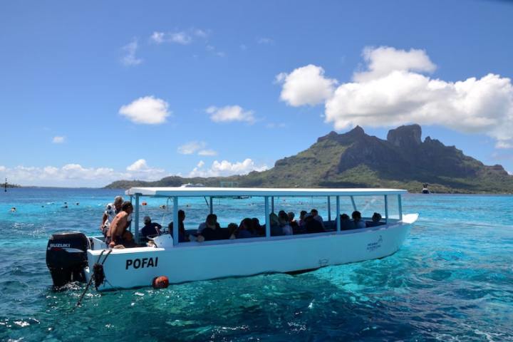 A group of people in a glass bottom boat in Bora Bora