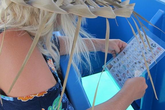 A woman watching fishes notice in Bora Bora