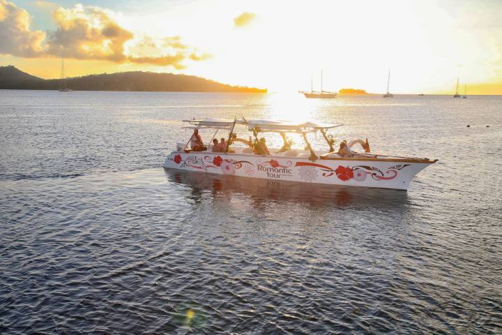 A Polynesian outrigger sailing in Bora Bora