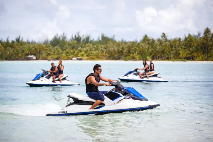A group of people jet skiing in Bora Bora