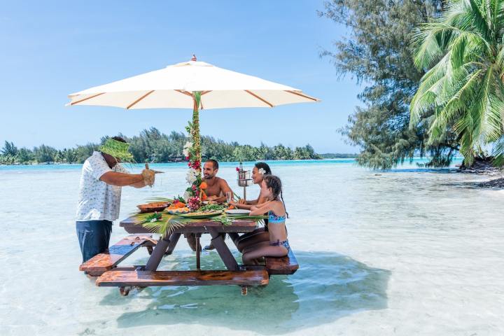 A man pouring fresh coconut milk on fish raw