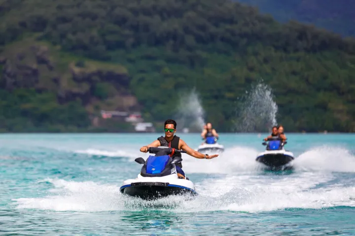 A group of people jet skiing in Bora Bora