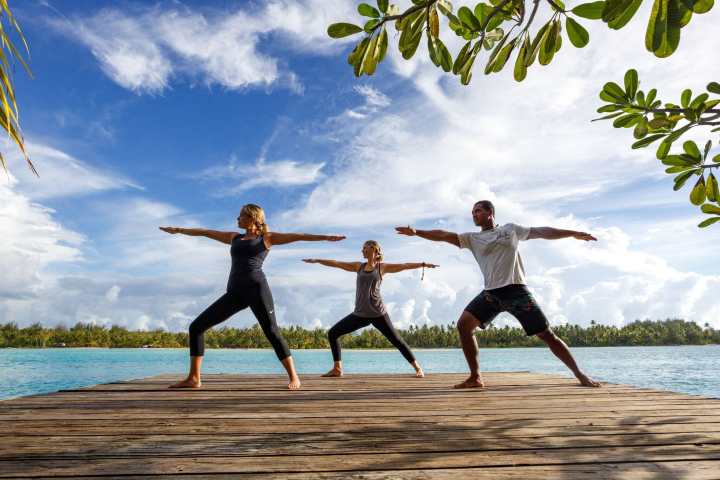 a couple of people on a beach near a body of water