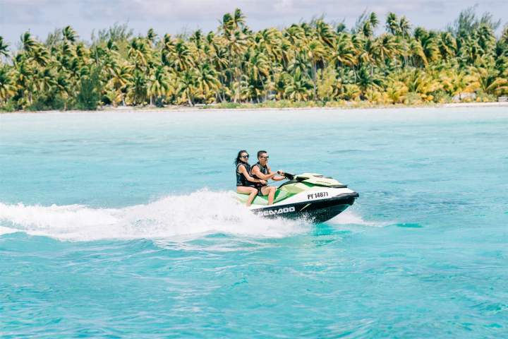 A couple jet skiing in Bora Bora