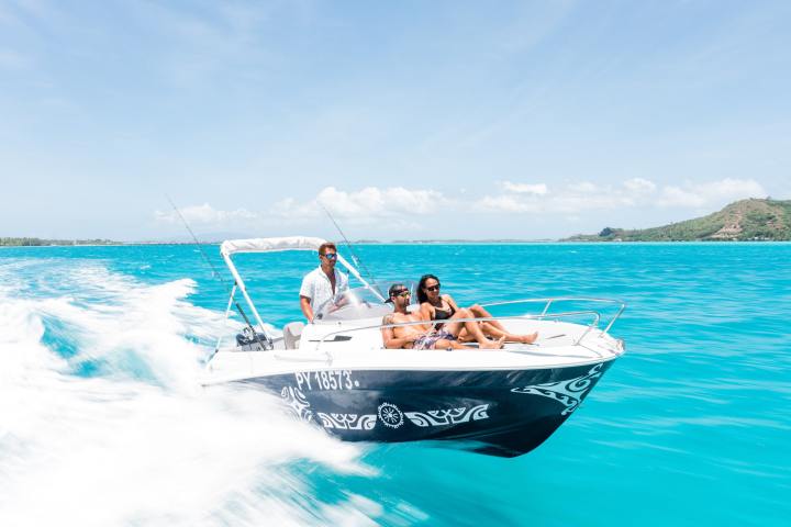 a person riding on the back of a boat in the water