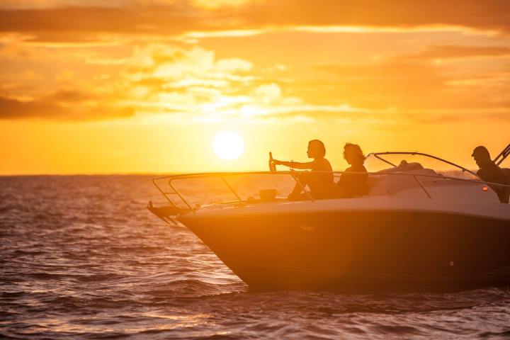 A couple having a glass of champagne onboard watching Bora Bora sunset