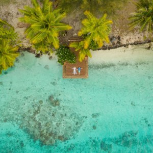 A couple resting on a private island in Bora Bora