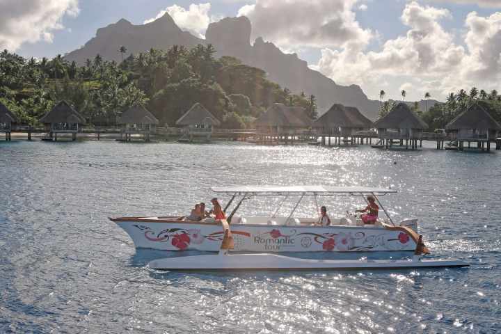 A Polynesian outrigger sailing in Bora Bora