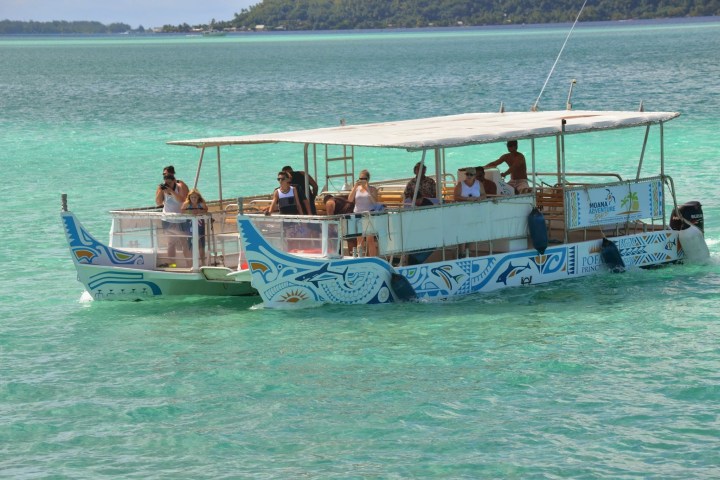 Moana Adventure Tours catamaran going on a tour with clients