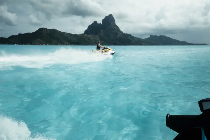 a person riding a wave on top of a body of water