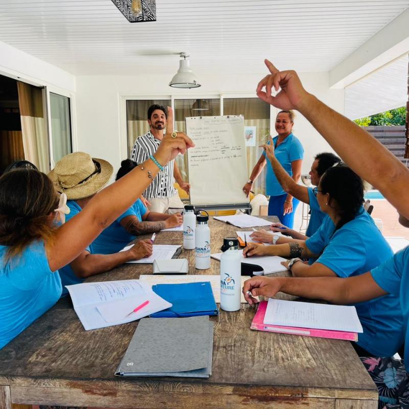 a group of people standing on top of a cutting board
