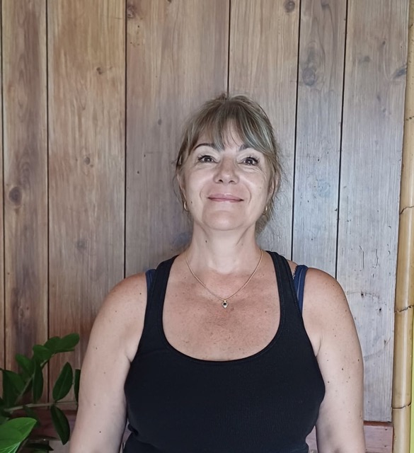 a woman standing in front of a wooden door