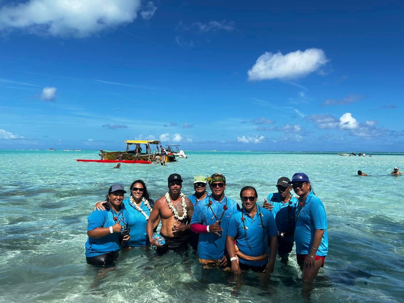 a group of people standing next to a body of water