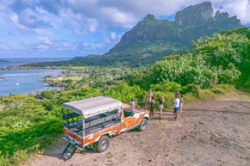 a group of people riding on the back of a truck