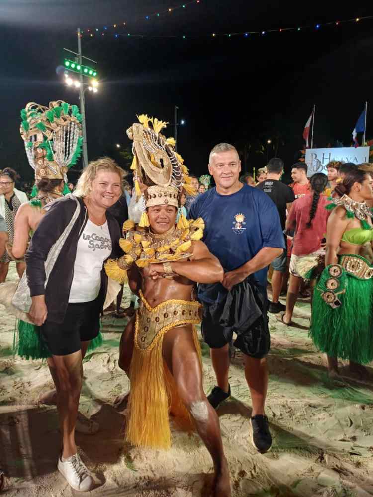 a group of people standing in front of a crowd posing for the camera
