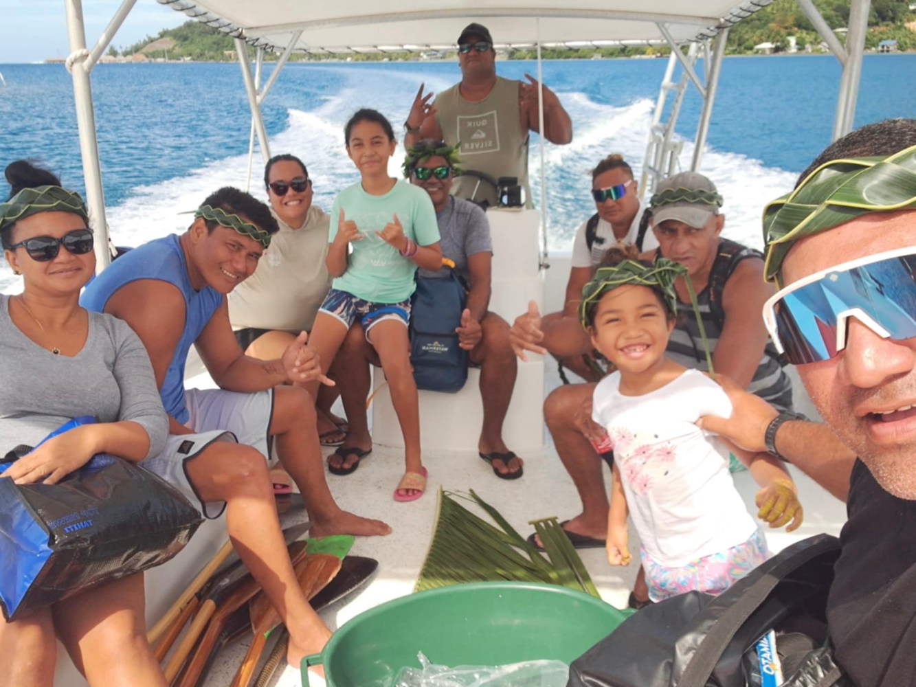 a group of people sitting in a boat on a body of water